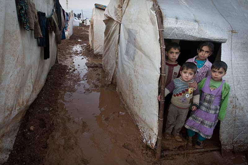 Children in a doorway in Syria, 2014. Photo:  © UNICEF/NYHQ2014-0003/Diffidenti