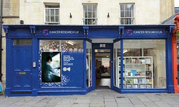 A Cancer Research UK shop with a contactless giving window