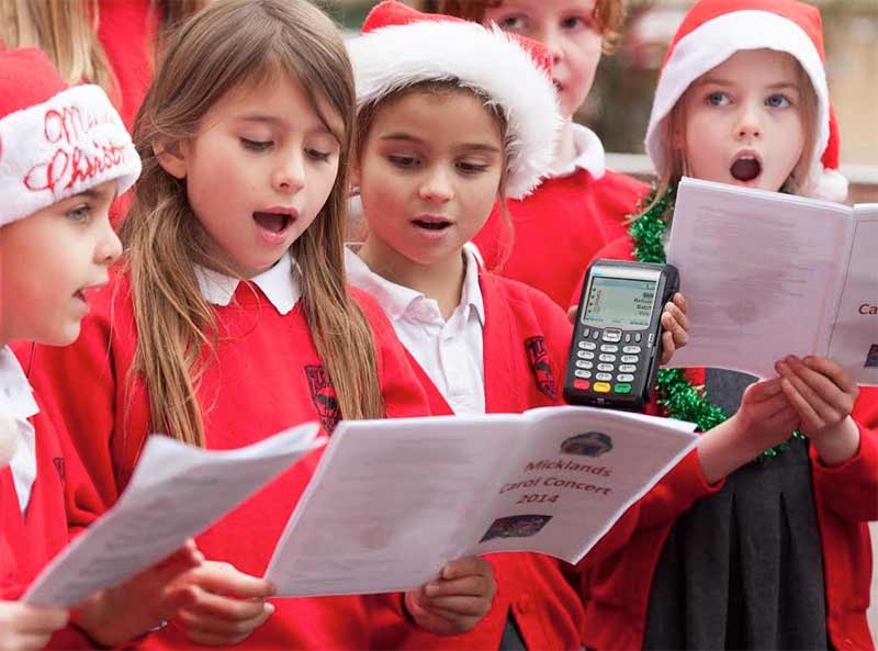 Micklands Primary School carol singers with chip and PIN card terminal
