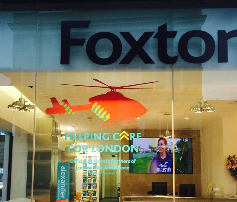 Foxton's window promotes its partnership with London's Air Ambulance